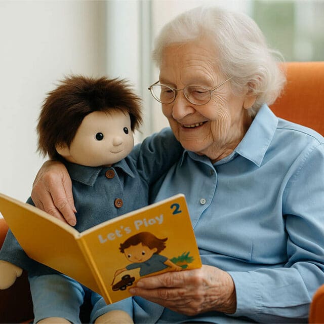 Elderly lady in care holding a therpay doll and reading to it